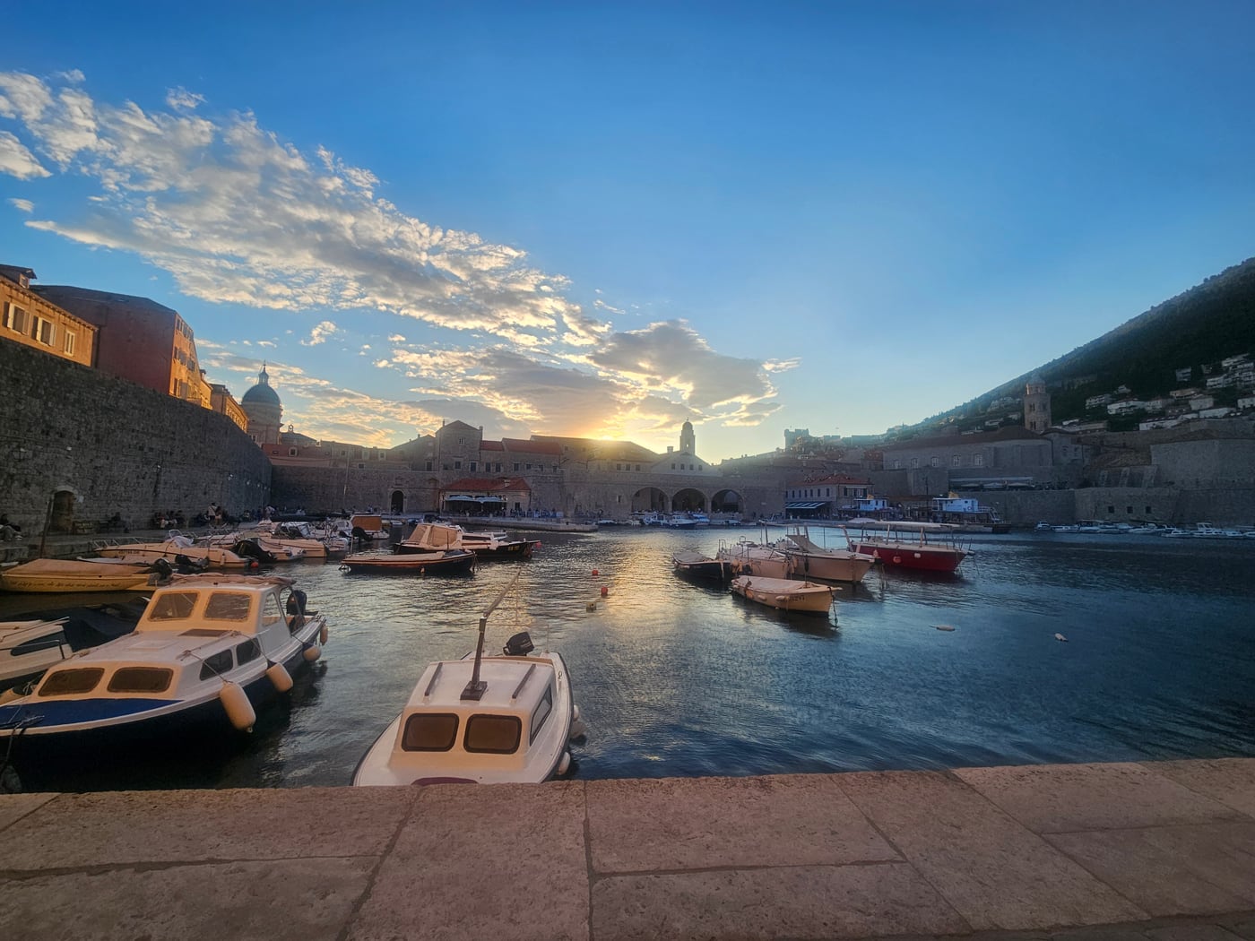 Abendstimmung am Hafen von Dubrovnik mit Booten und Stadtmauer